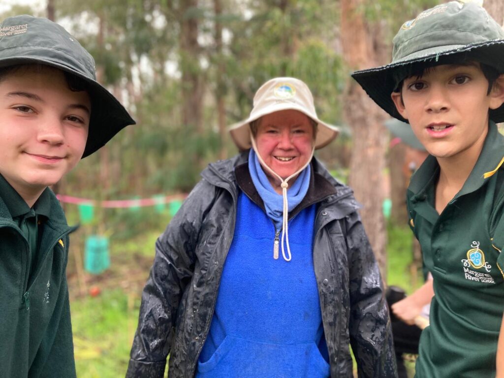 Maureen Munro planting with students low res